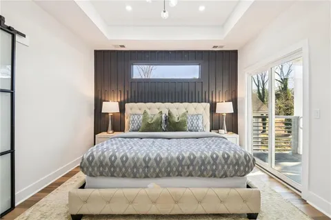 a large bed sitting in a bedroom next to a window