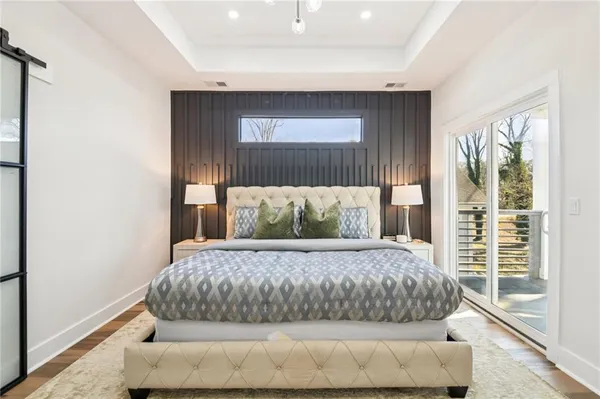 a large bed sitting in a bedroom next to a window