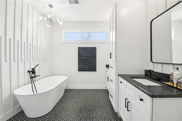 a bathroom with a bathtub and a sink