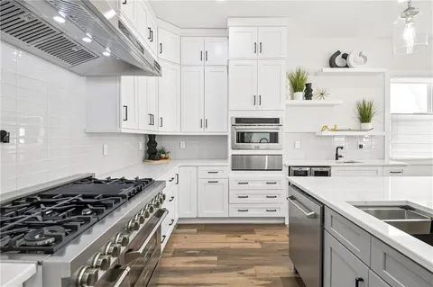 a kitchen with cabinets appliances and a window
