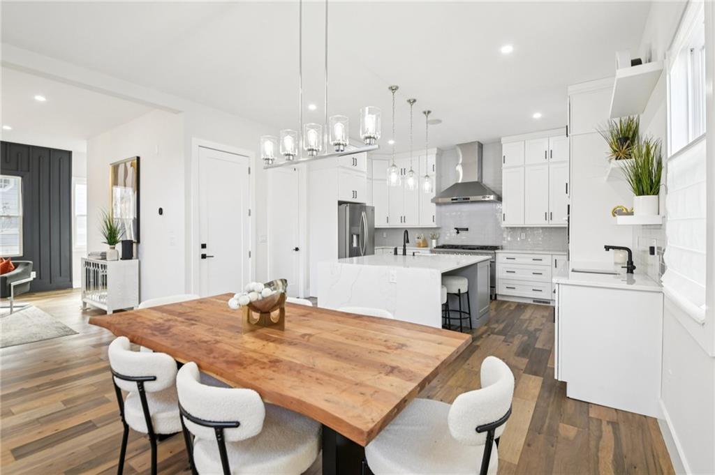 2014 Cambridge Avenue Atlanta, GA 30337 - Photo 9 of 34 a kitchen with stainless steel appliances kitchen island a table and chairs in it