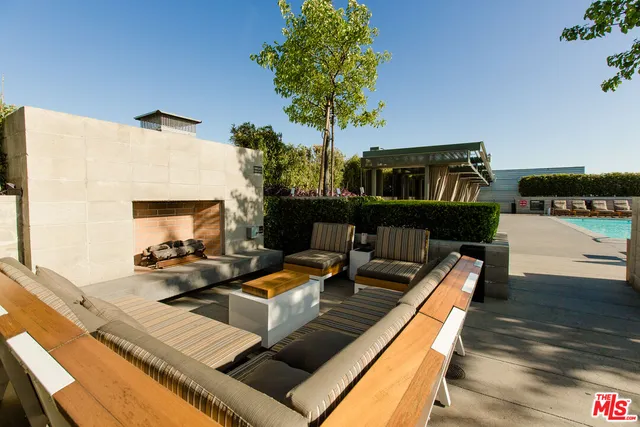 a view of a balcony with chairs and a potted plant