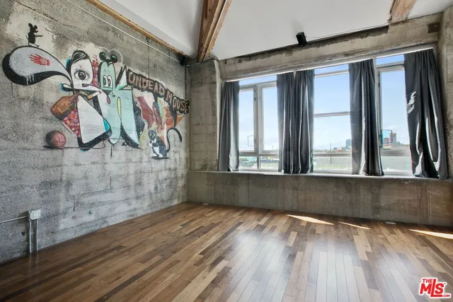 a view of a room with window and wooden floor