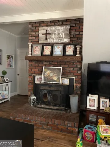 a room with table chairs and flat screen tv