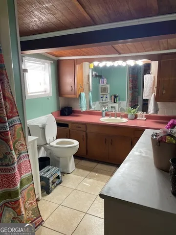 a bed room with a bed and a television