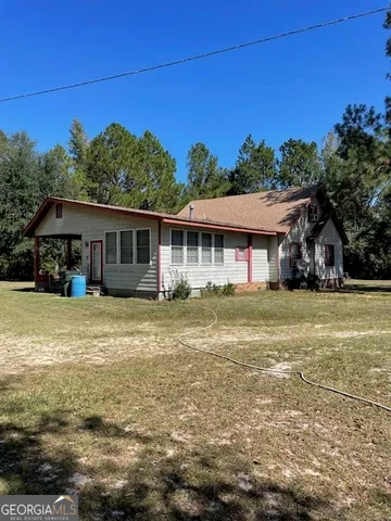 a kitchen with granite countertop a sink cabinets and stainless steel appliances