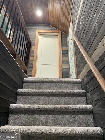 a view of staircase with lots of frames on wall