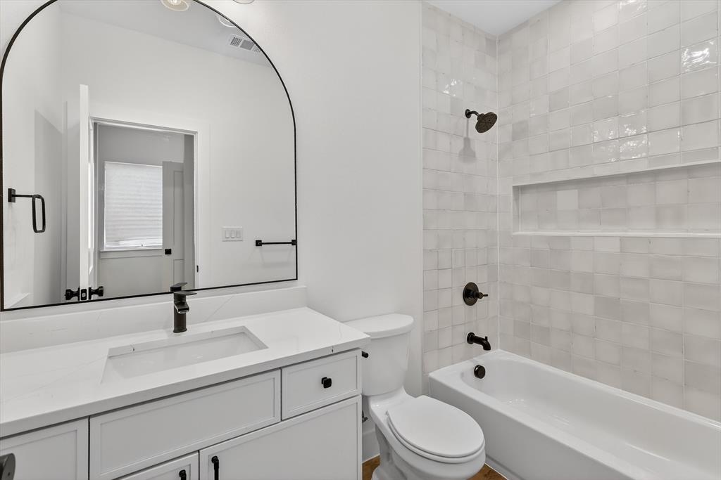 2835 Macon Street Dallas, TX 75215 - Photo 12 of 14 a bathroom with a sink a toilet and shower