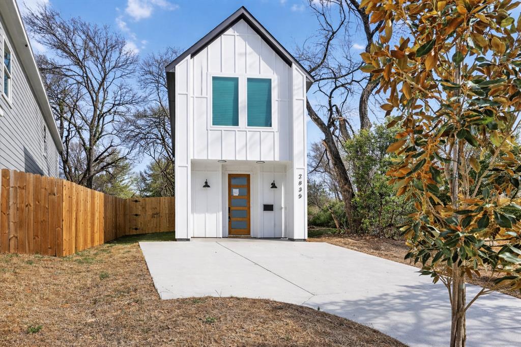2835 Macon Street Dallas, TX 75215 - Photo 2 of 14 a front view of a house with a yard and garage