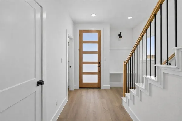 a view of an entryway with wooden floor and stairs