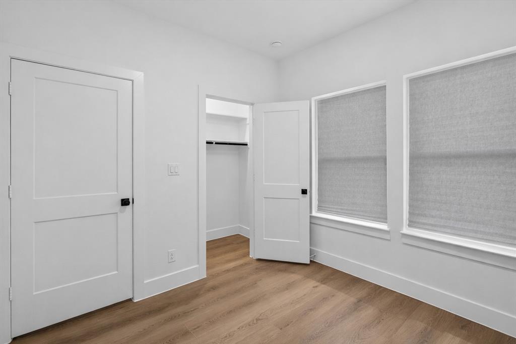 2835 Macon Street Dallas, TX 75215 - Photo 8 of 14 a view of an empty room with wooden floor and closet area