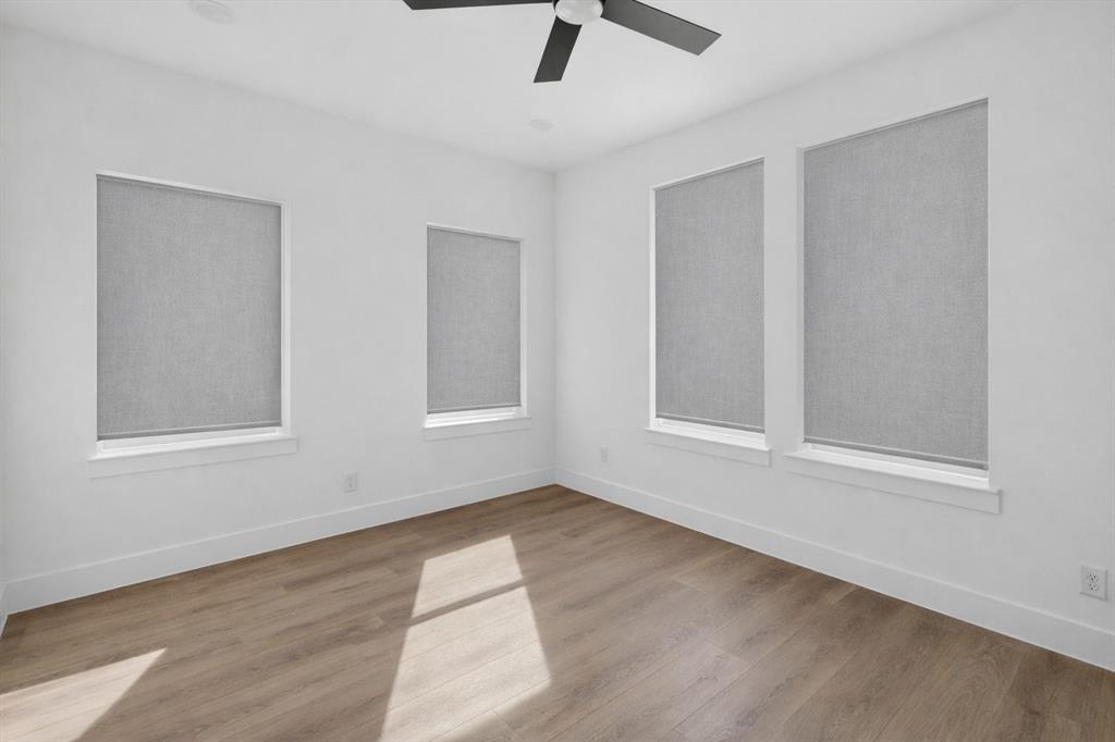 2835 Macon Street Dallas, TX 75215 - Photo 9 of 14 an empty room with wooden floor fan and windows