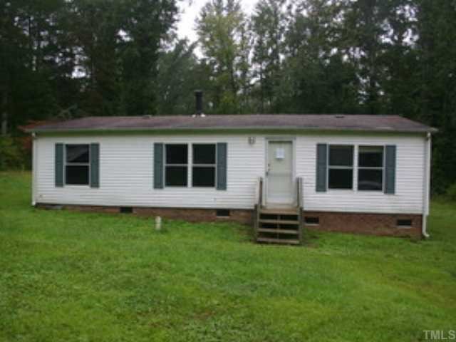 12517 Roxboro Road Rougemont, NC 27572 - Photo 1 of 3 a front view of a house with a garden