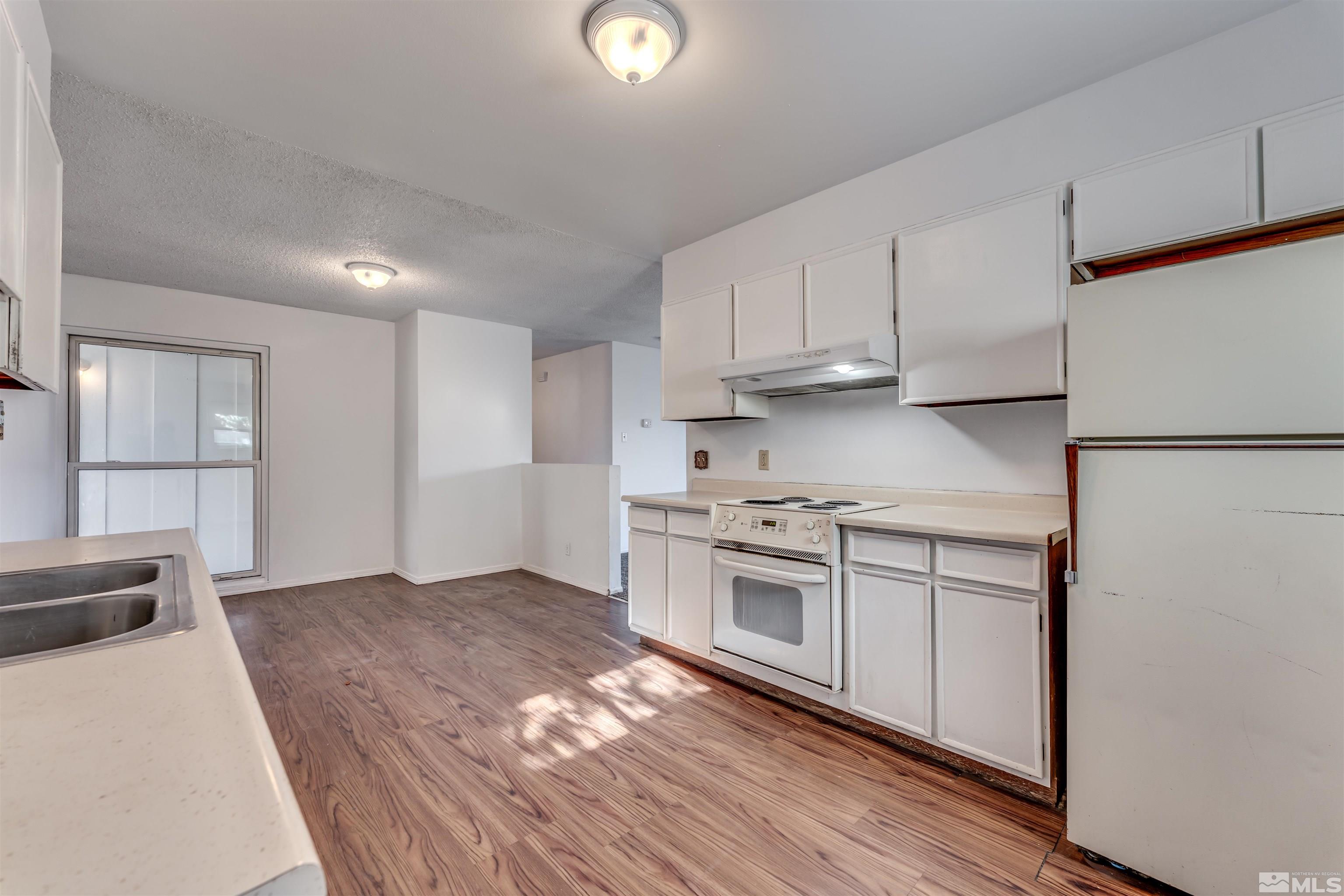 658 Beldon Way Reno, NV 89503 - Photo 10 of 21 a kitchen with stainless steel appliances granite countertop a stove a sink and a refrigerator