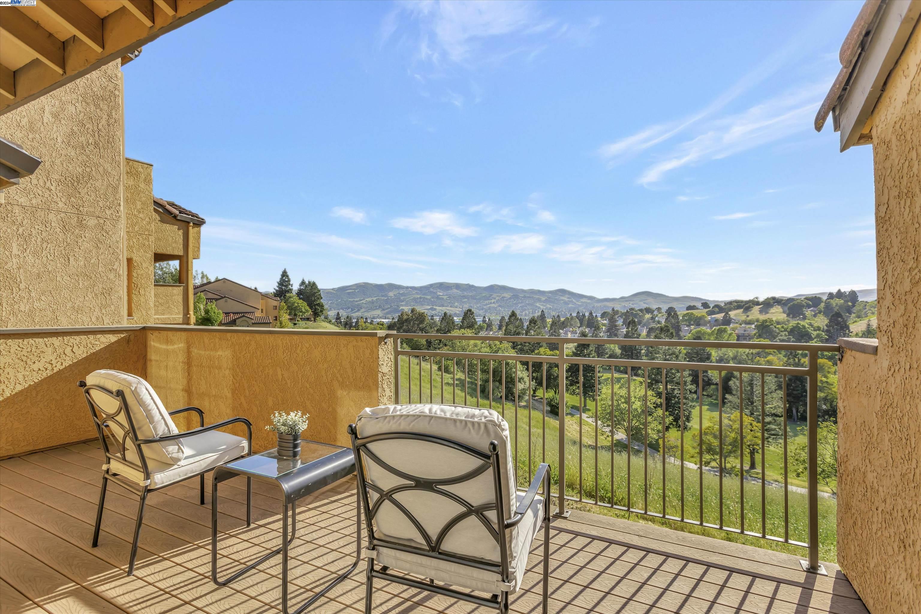 795 Watson Canyon Court, Unit 257 San Ramon, CA 94582 - Photo 1 of 1 a view of a lake with table and chairs