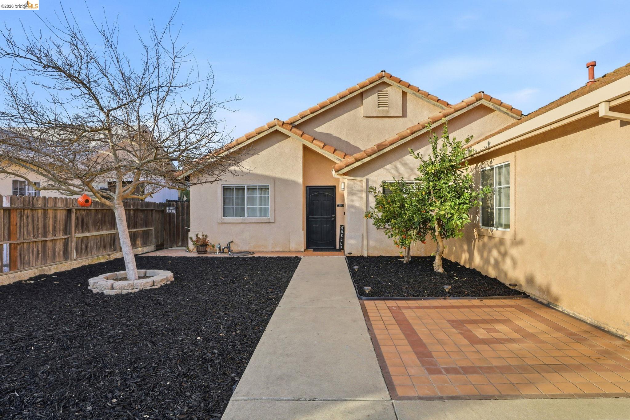 799 Morgans Ranch Circle Galt, CA 95632 - Photo 4 of 36 Entrance to property featuring stucco siding and a tiled roof