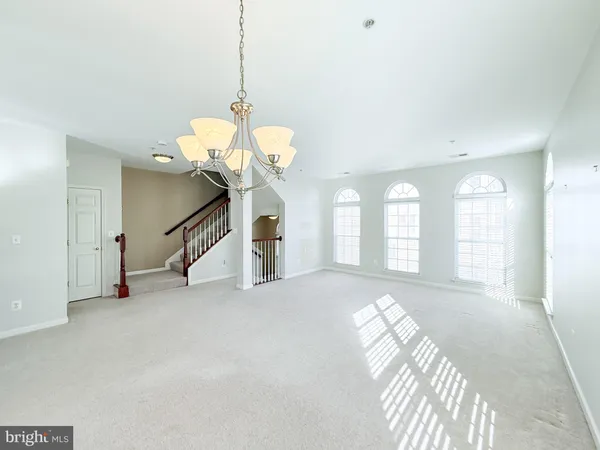 a view of a room with windows and wooden floor