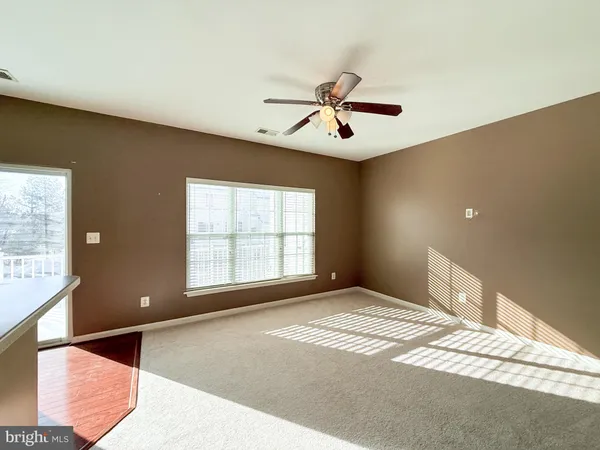 a view of a livingroom with a ceiling fan and window