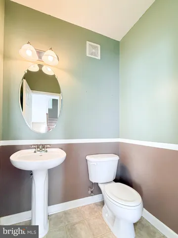 a bathroom with a sink a mirror and a toilet