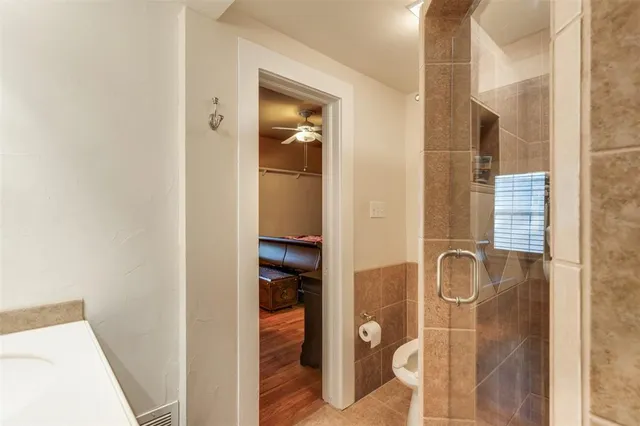 a bathroom with a sink shower and a mirror