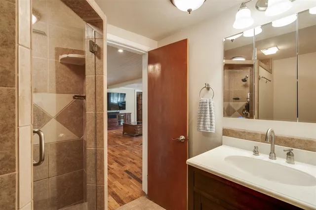 a bed sitting in a spacious bedroom next to a window