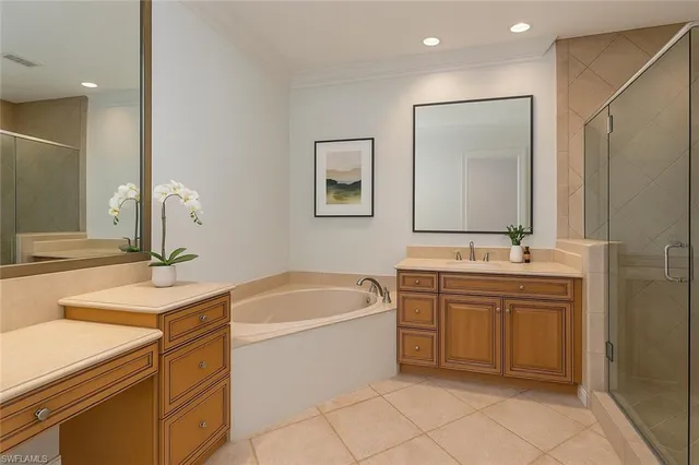 a bathroom with a sink vanity and tub