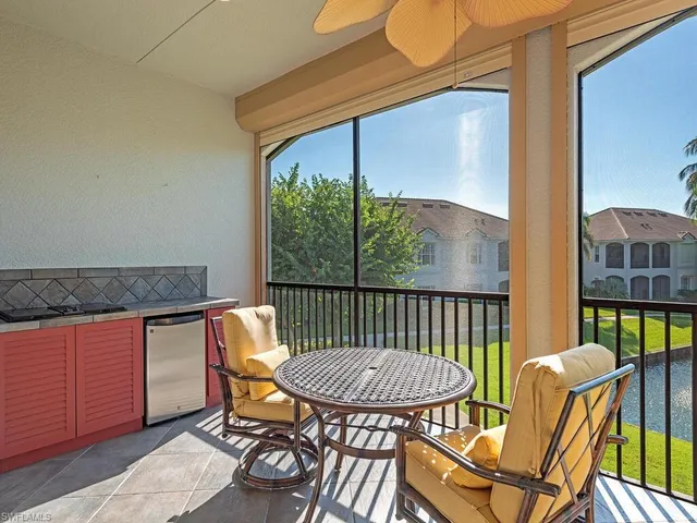 a front view of a house with a yard and lake view
