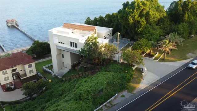 a front view of a house with a yard and mountain view