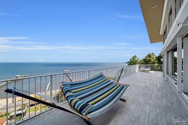 a view of a dining room with furniture wooden floor and chandelier