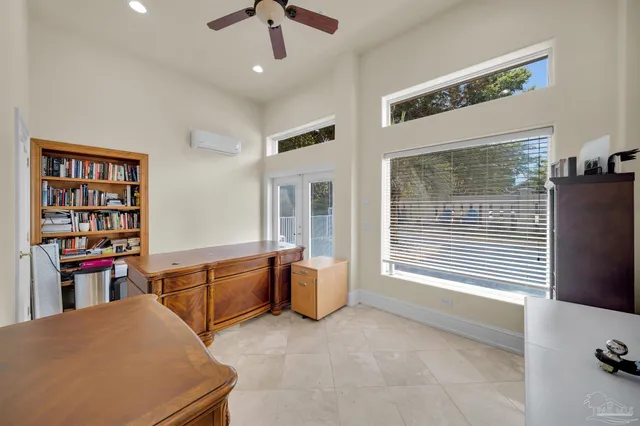 a bedroom with a bed and a large window