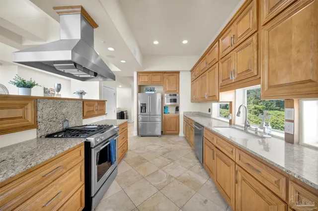 a bedroom with a bed and a computer on desk next to a window