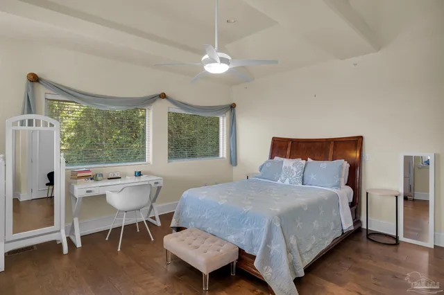 a view of empty room with wooden floor and floor to ceiling window