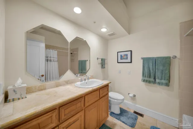 a bathroom with a shower a toilet and a sink