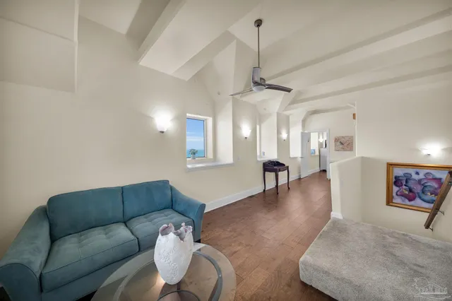 a view of a house with a yard and potted plants