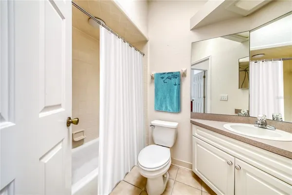 a large bed in a bedroom next to a cabinet