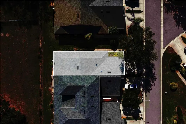 an aerial view of a house with a yard swimming pool and outdoor seating