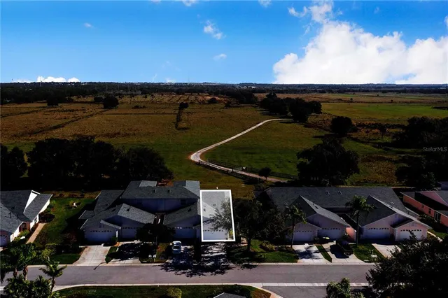 an aerial view of multiple houses with outdoor space