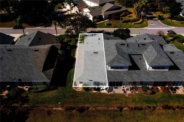 an aerial view of a houses with yard