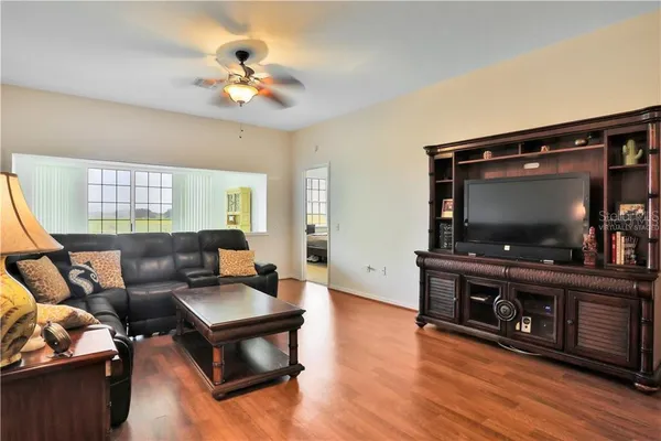 a living room with furniture fireplace and a large window
