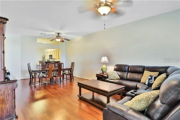 a view of a dining room with furniture and wooden floor