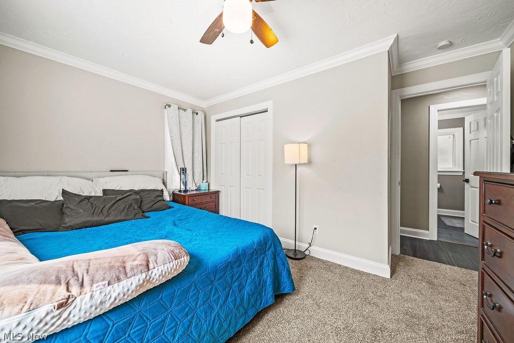 6366 Engle Road Brook Park, OH 44142 - Photo 27 of 38 Carpeted bedroom with crown molding, ceiling fan, and a closet