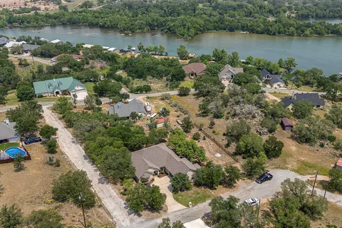 an aerial view of a houses with a lake view