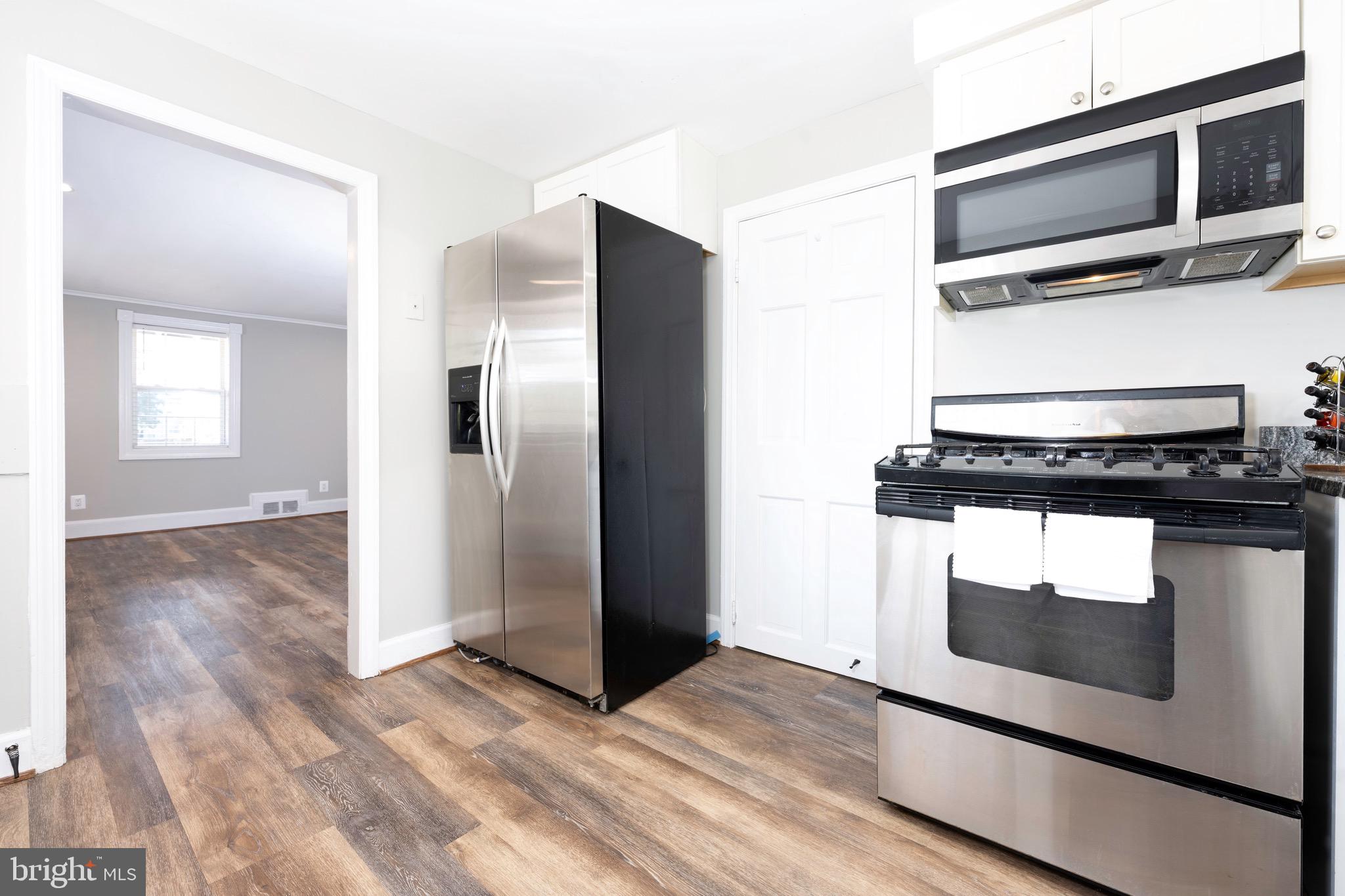 8547 Emory Grove Road Gaithersburg, MD 20877 - Photo 7 of 18 a kitchen with a stove and a microwave