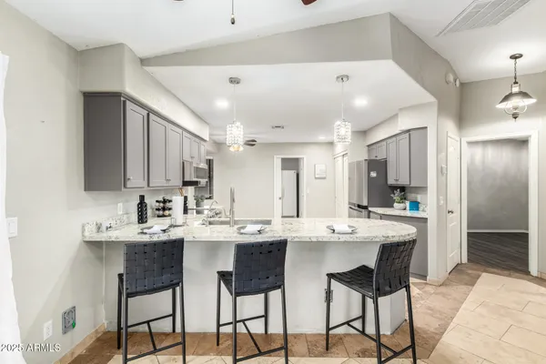 a kitchen with stainless steel appliances kitchen island granite countertop a sink and cabinets