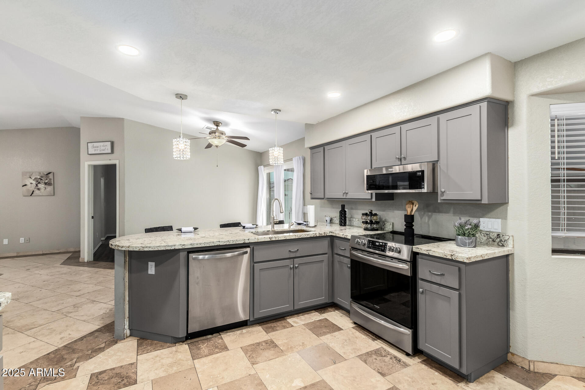 540 South Stardust Lane Apache Junction, AZ 85120 - Photo 19 of 32 a kitchen with stainless steel appliances granite countertop a sink a stove top oven a counter space and cabinets