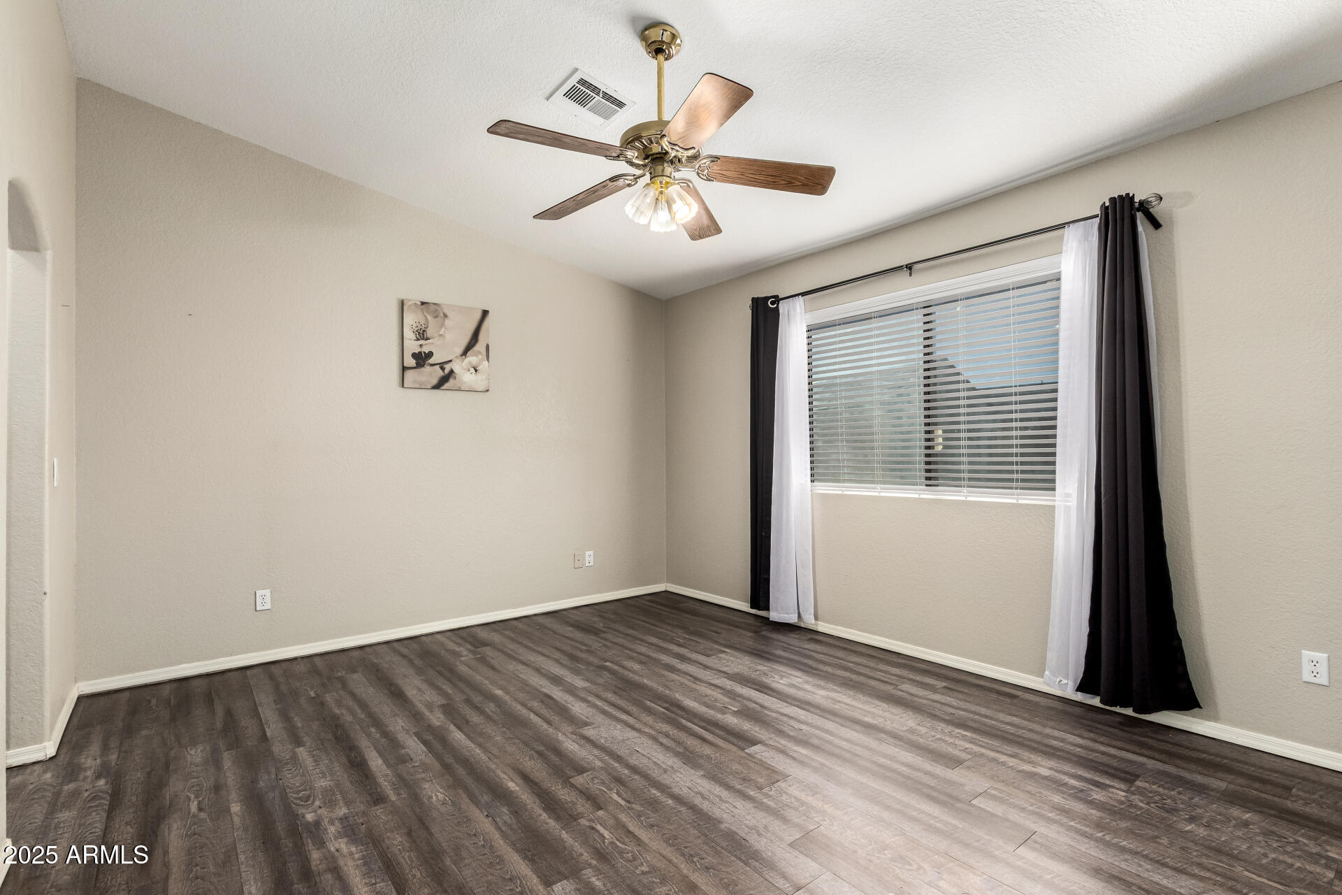 540 South Stardust Lane Apache Junction, AZ 85120 - Photo 23 of 32 a view of an empty room with wooden floor and a window