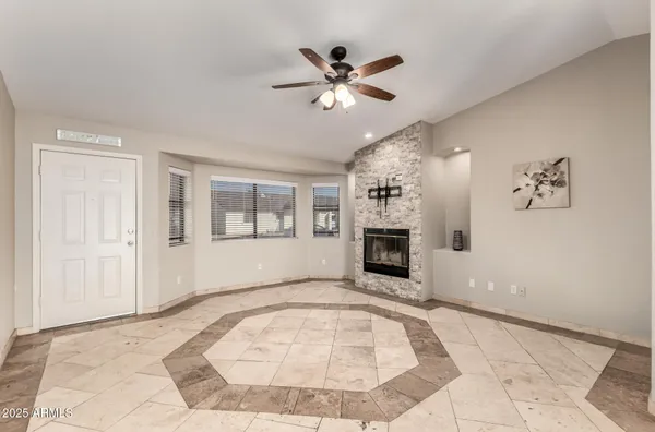 an empty room with fireplace and windows