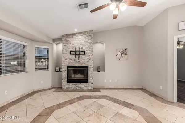 a view of empty room with a fireplace