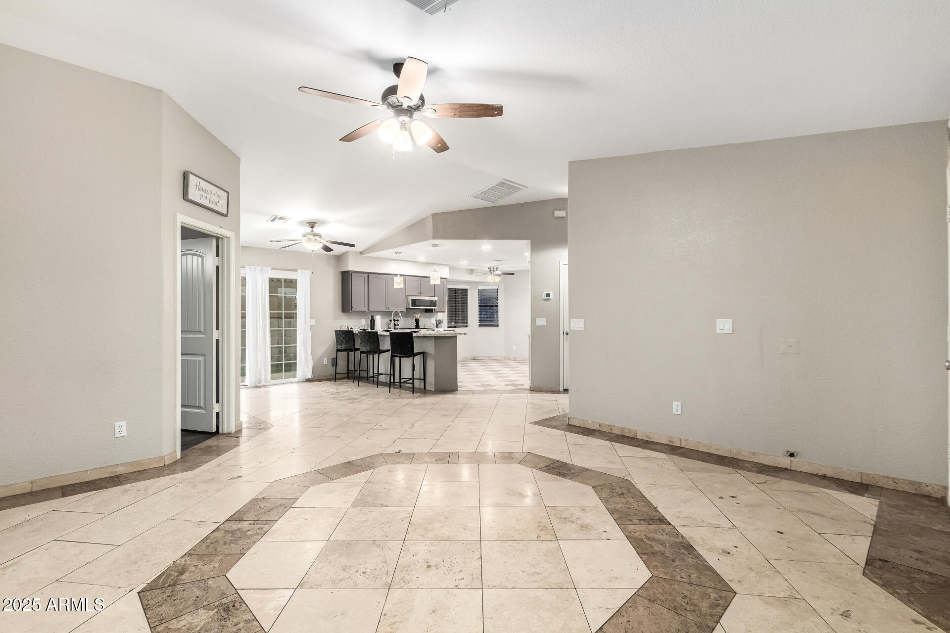540 South Stardust Lane Apache Junction, AZ 85120 - Photo 7 of 32 a view of a livingroom with a dinning area hardwood floor and a ceiling fan
