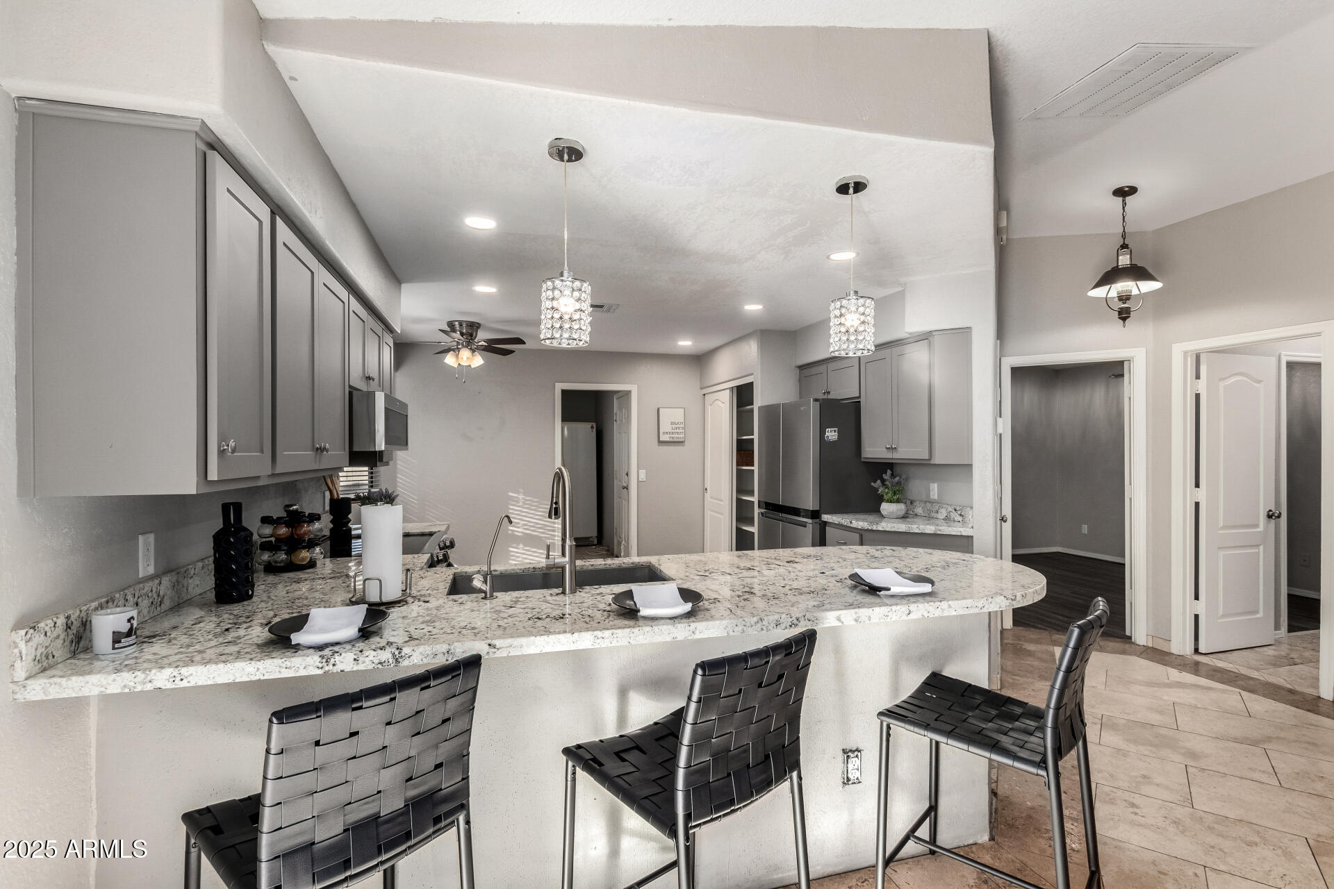 540 South Stardust Lane Apache Junction, AZ 85120 - Photo 10 of 32 a kitchen with a dining table chairs sink and cabinets